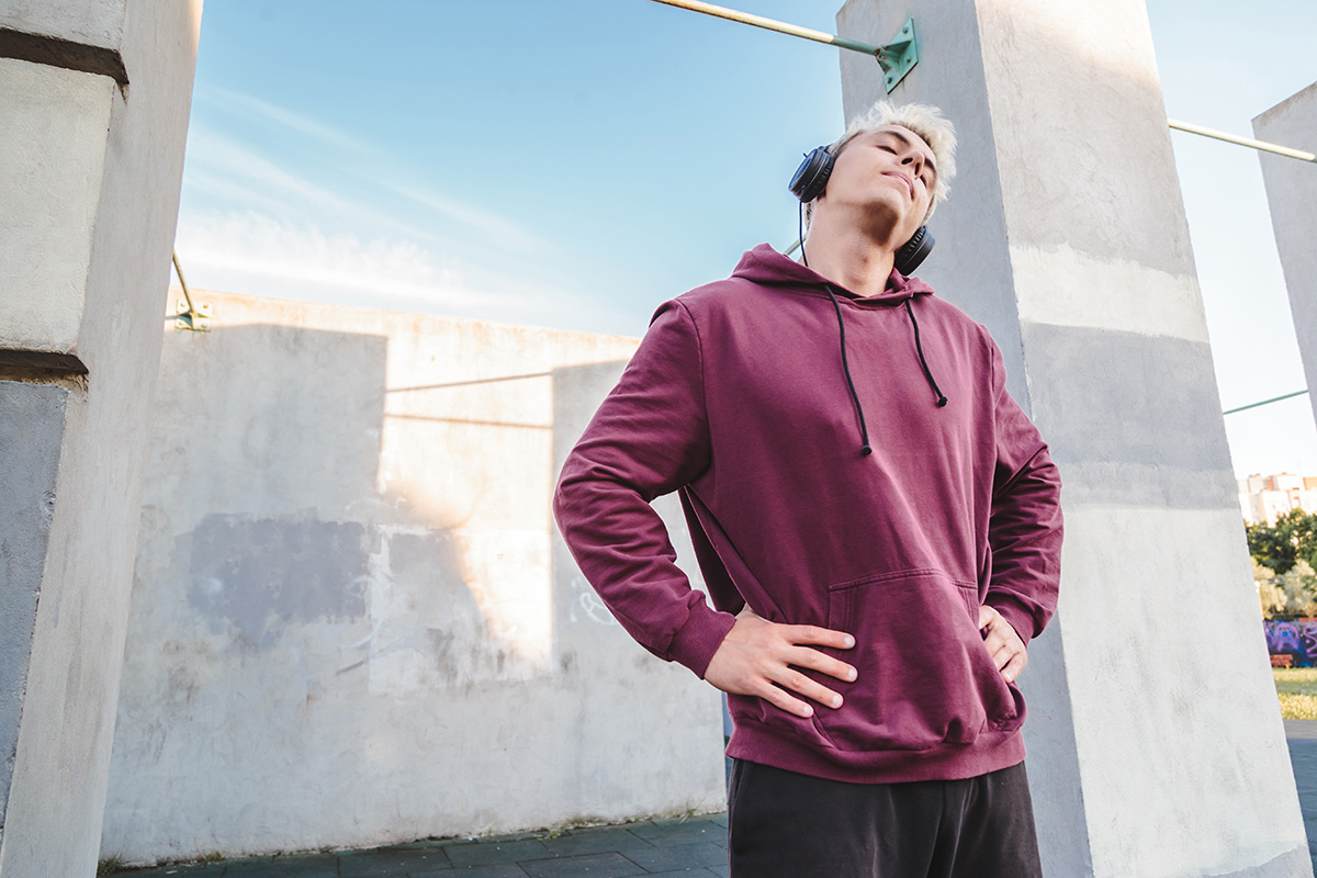 Athlete stretching neck to show how to warm up before playing sports.